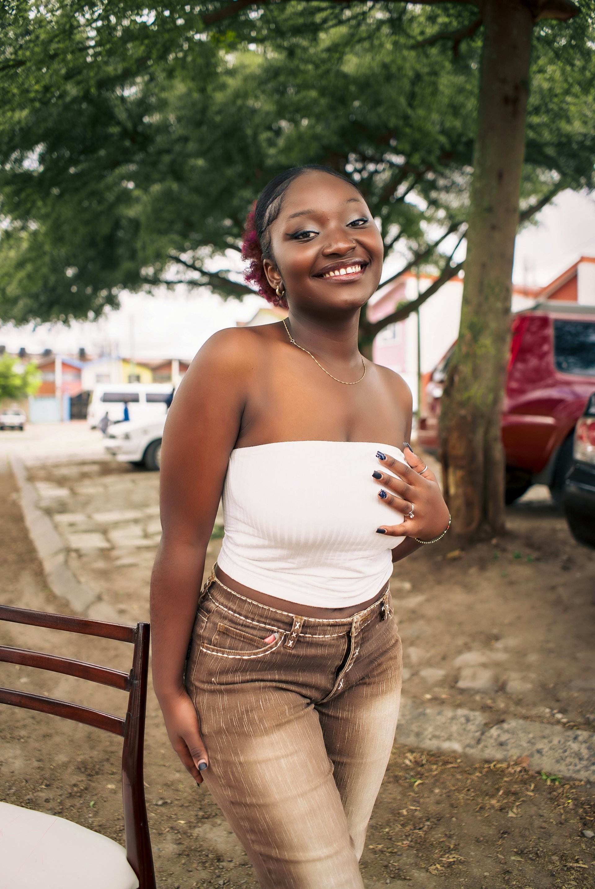 Young Black woman smiling, wearing casual clothing, creator aesthetic